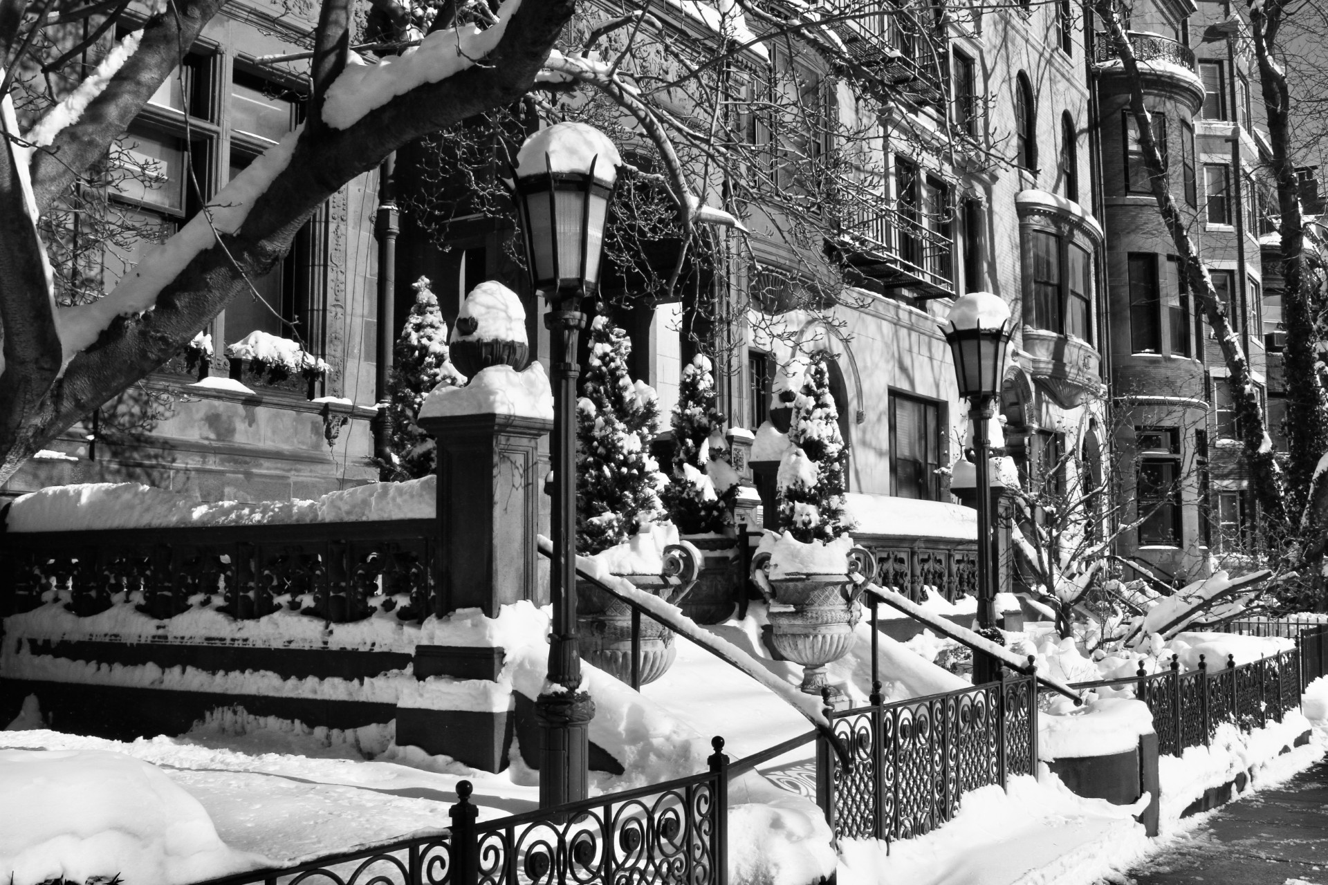 Snow-covered brownstone apartments with lamppost, Boston